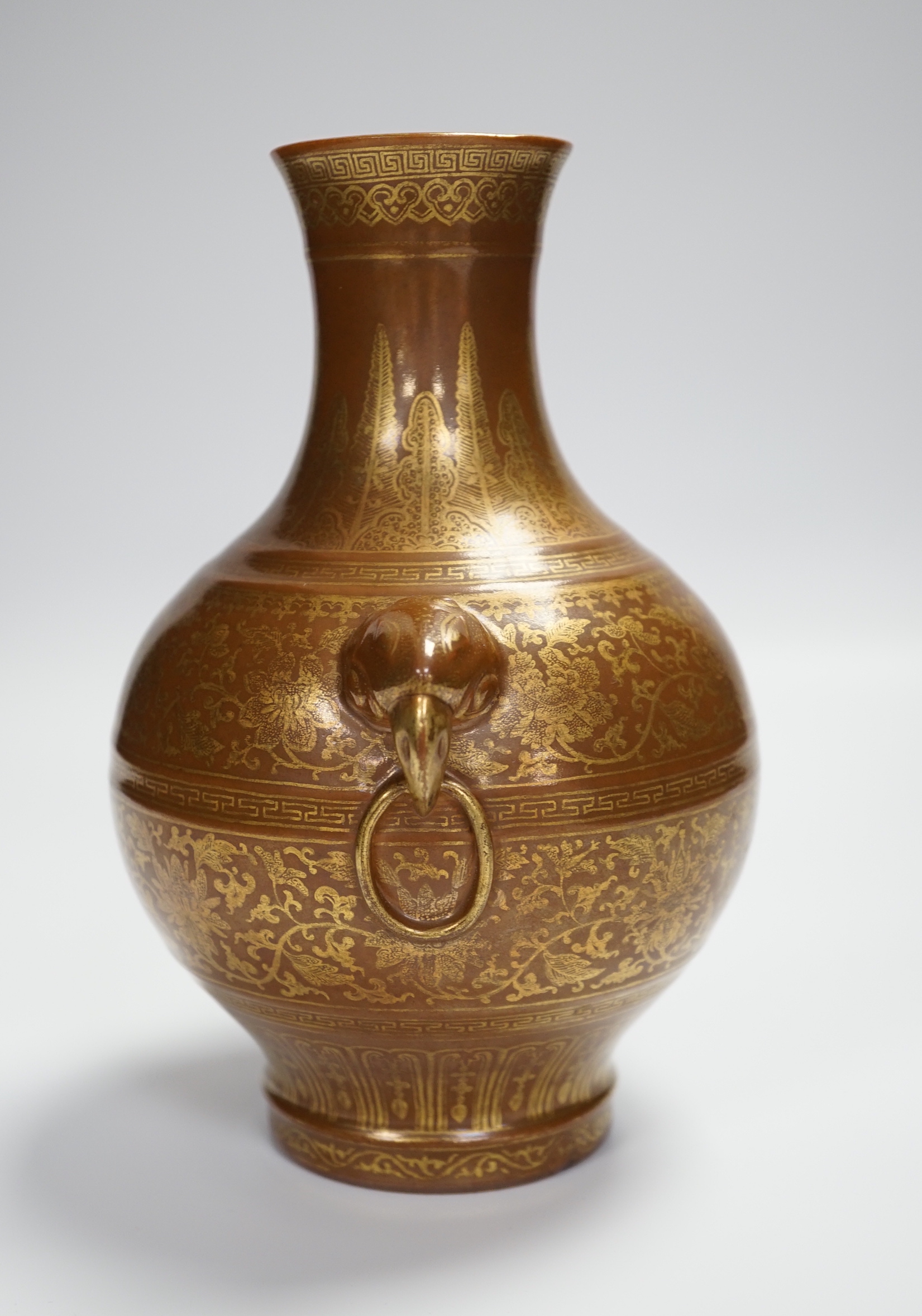 A Chinese porcelain imitation bronze vase, on a brown ground with gilt decoration, 19.5cm high